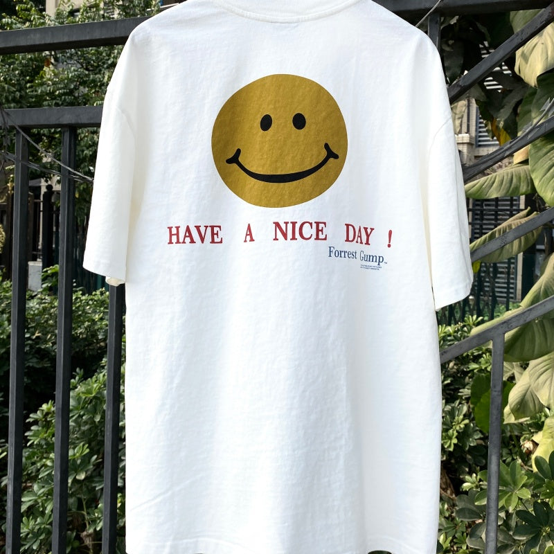 Unisex Vintage T Shirts "Have a nice day!" — Limited-edition smiley face design featuring direct-to-garment white ink printing; vintage style with a heavyweight, washed, and distressed finish.